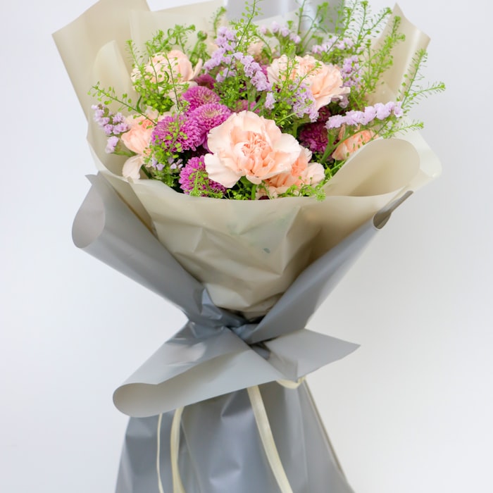 Blush Bloom Box on a bedside table